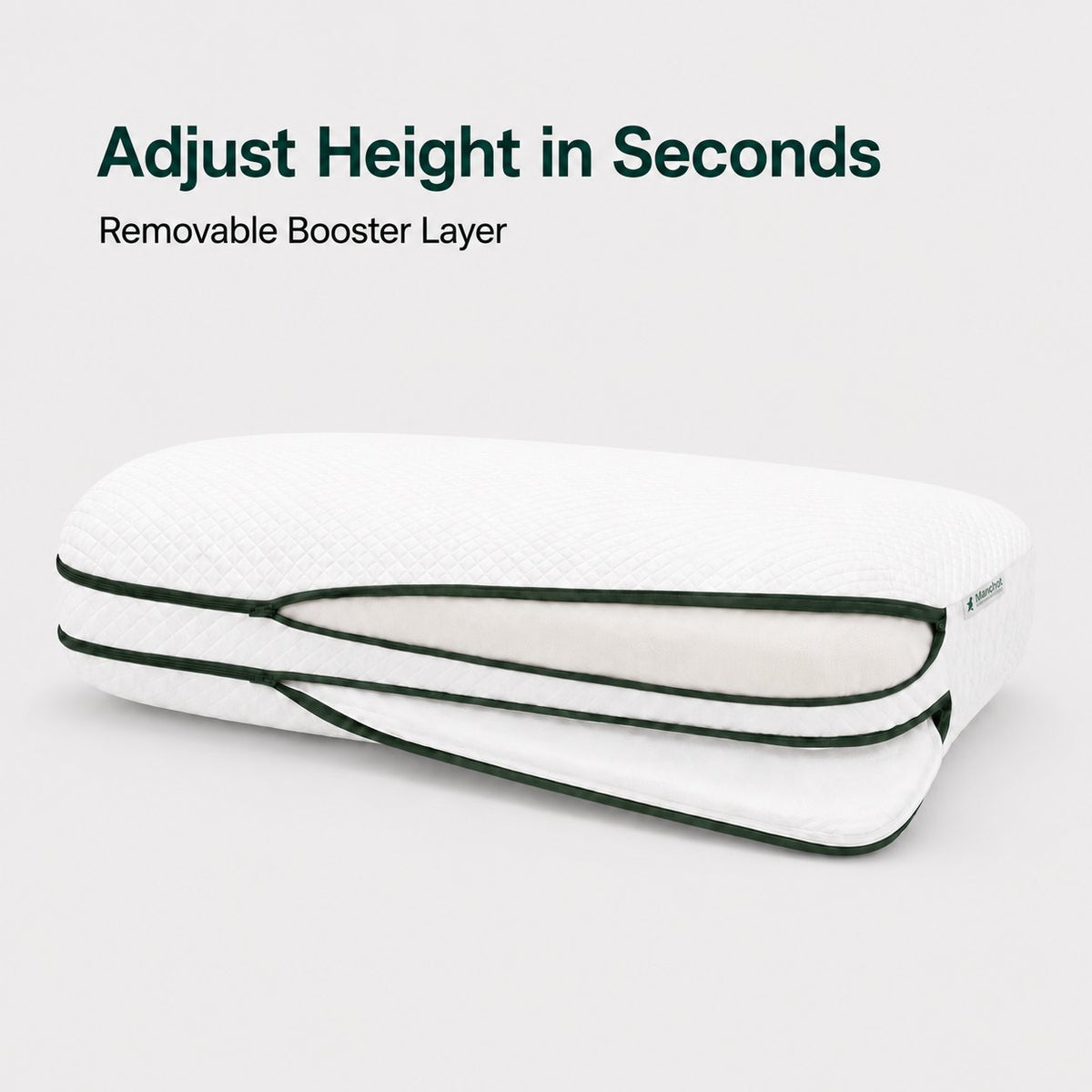 Manchot Cradle adjustable pillow opened to show the removable height booster layer