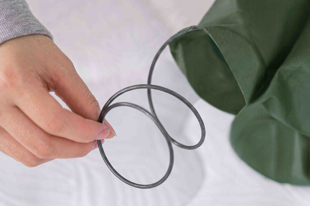 A pocket coil held in a hand.